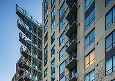 Stacked balconies on a residential high-rise at dusk