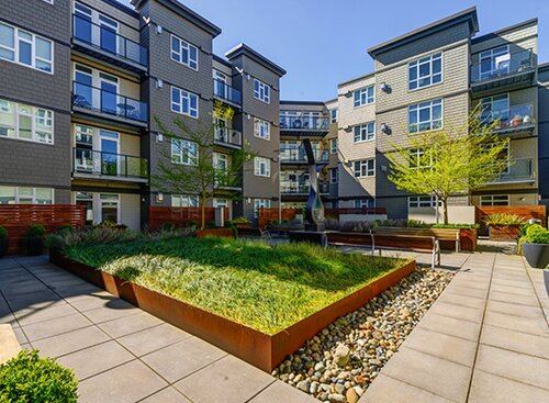 Landscaped apartment courtyard with planters and seating
