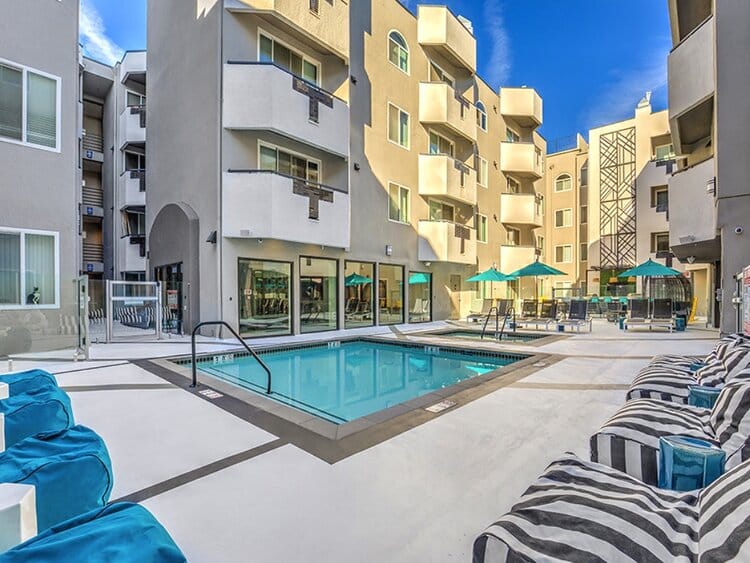 Apartment pool deck with cabanas and lounge seating