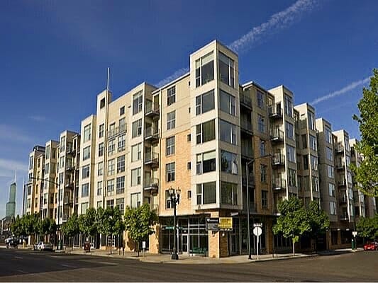 Six-story urban apartment building with ground-floor retail